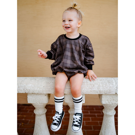 Toddler boy wearing our Soft, Cotton Sweater Bubble in our dark Charcoal Gray and Black Plaid abstract print