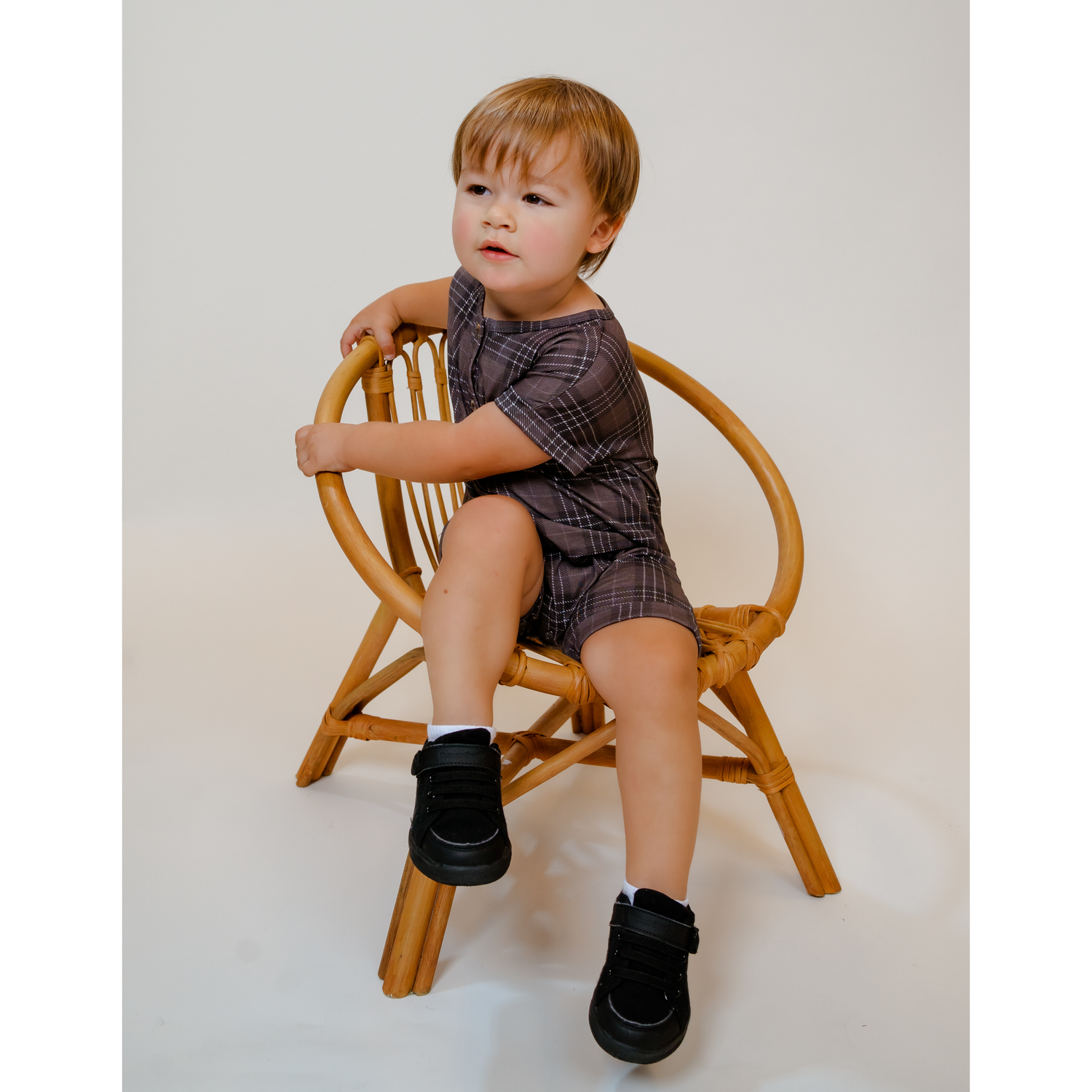 Toddler wearing our soft, Bamboo Shortie Jumpsuit Romper in dark Charcoal Gray and Black Plaid abstract print